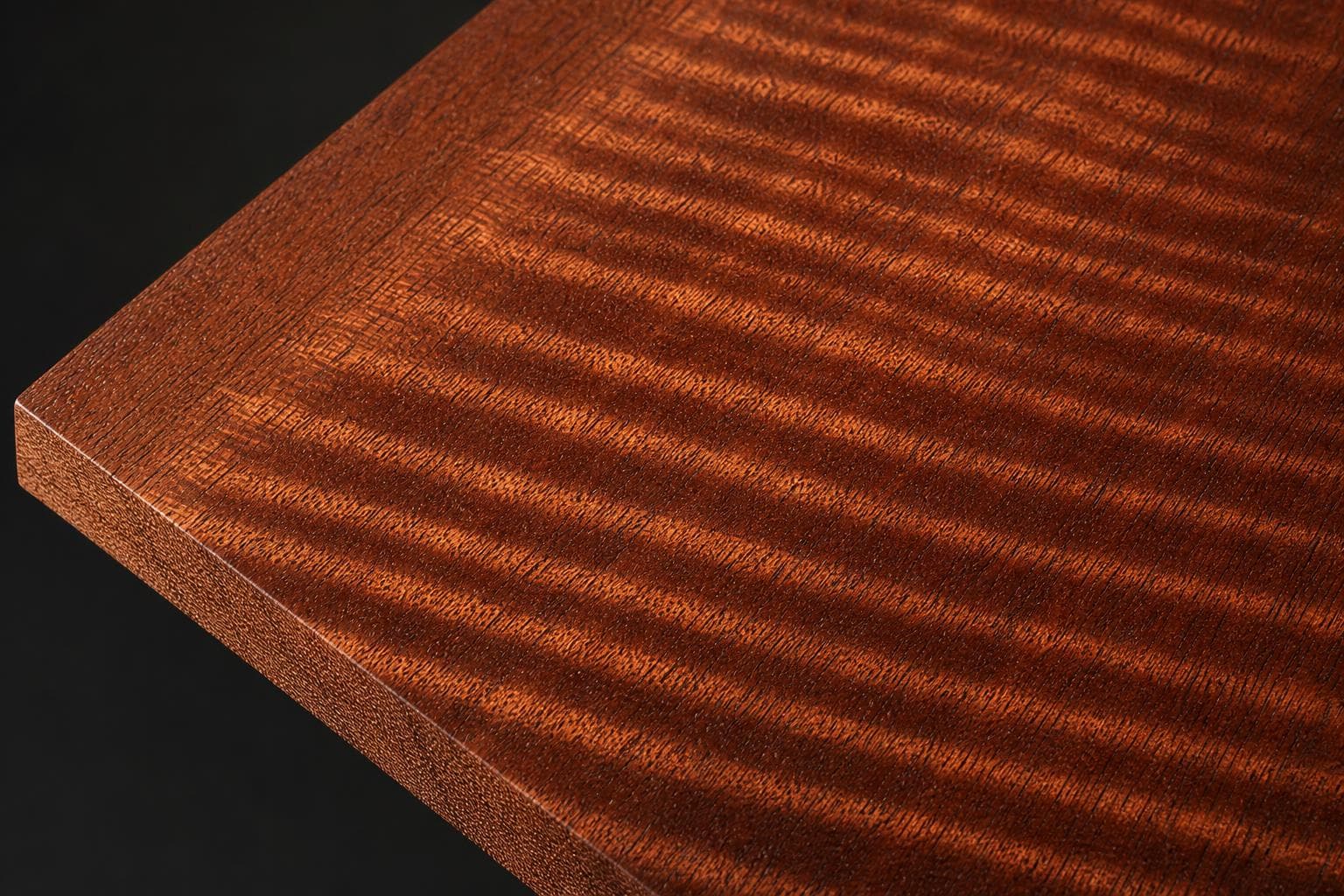 Sapele board with a ribbon-striped figure, close-up of the face and edge